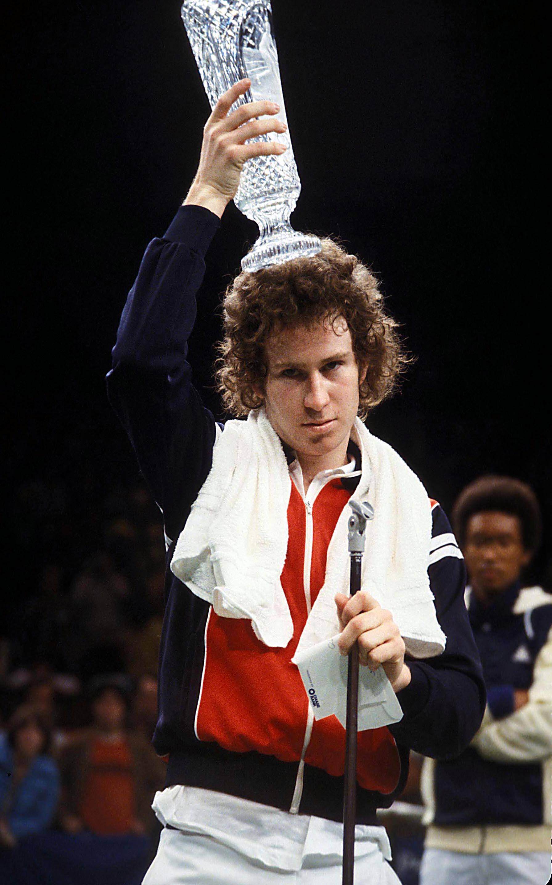 John McEnroe trophy on his head