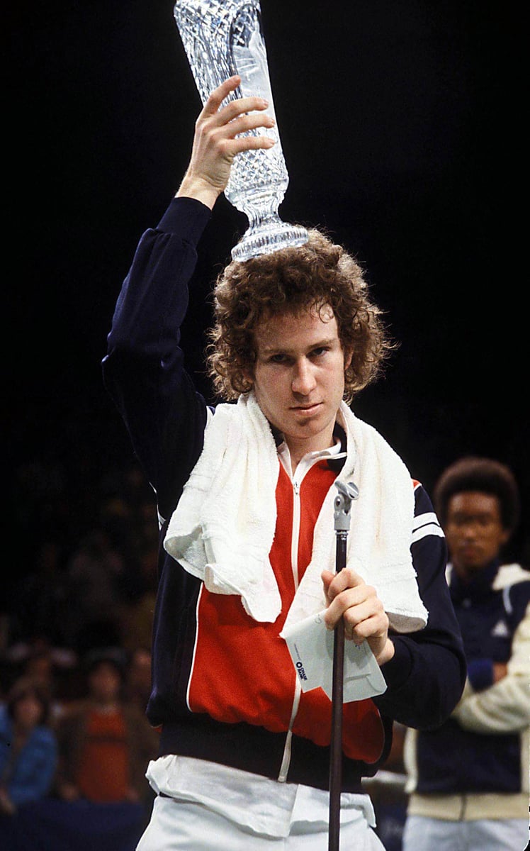 John McEnroe trophy on his head