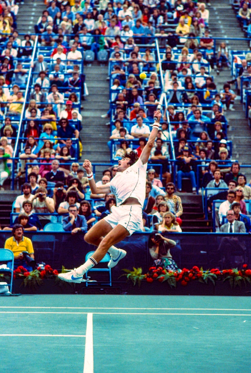 Jimmy Connors hits ball in the air