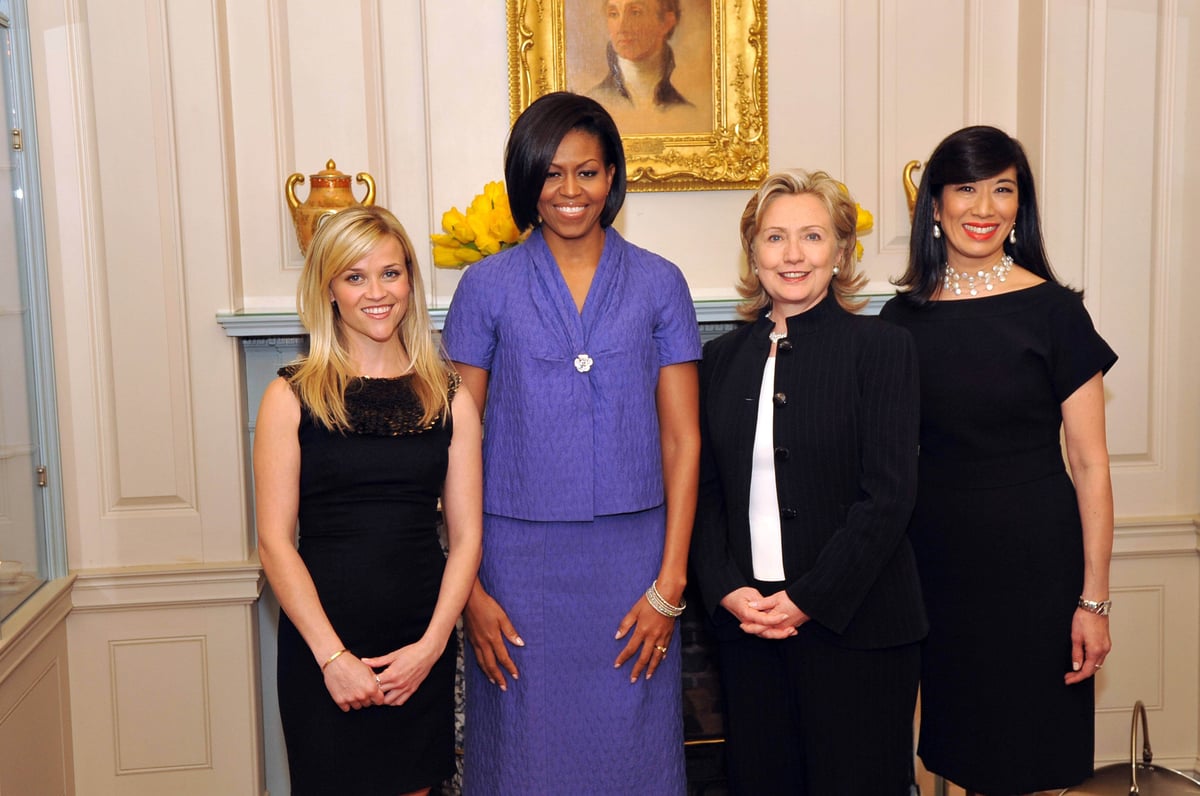 US Secretary of State Hillary Rodham Clinton stands with actress Reese Witherspoon, First Lady Michelle Obama, and Avon Chairwoman and CEO Andrea Jung at the 2010 International Women of Courage Awards.