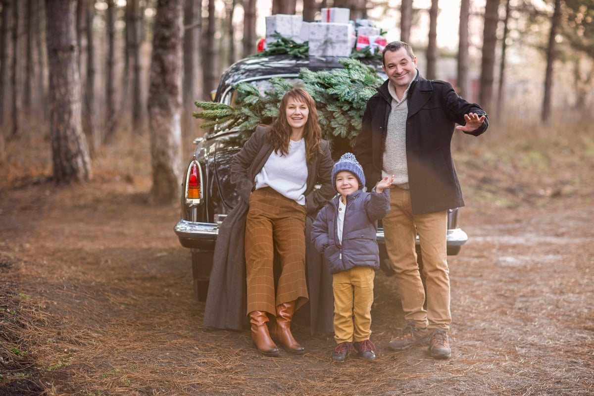 family with a christmas tree in the car image