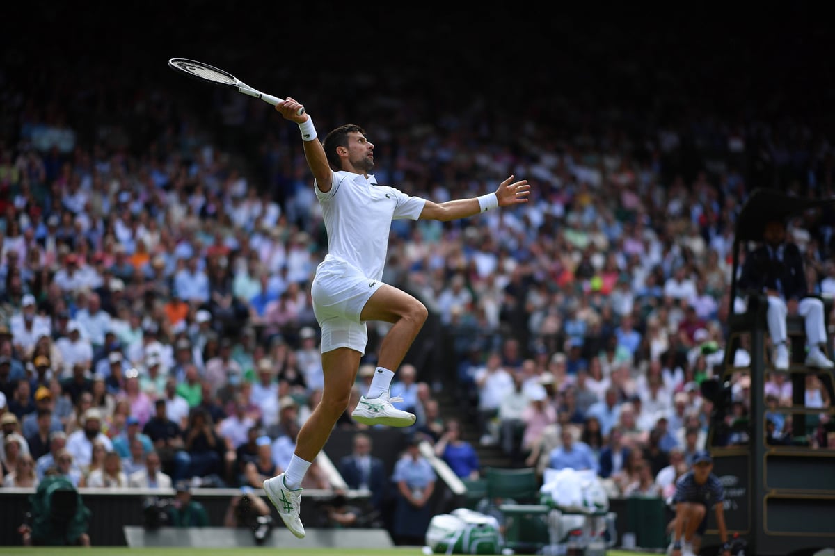 Novak Djokovic hits the ball mid-air