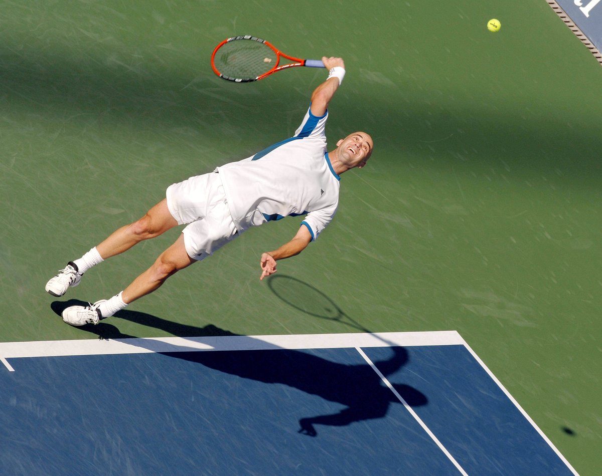 Andre Agassi serves