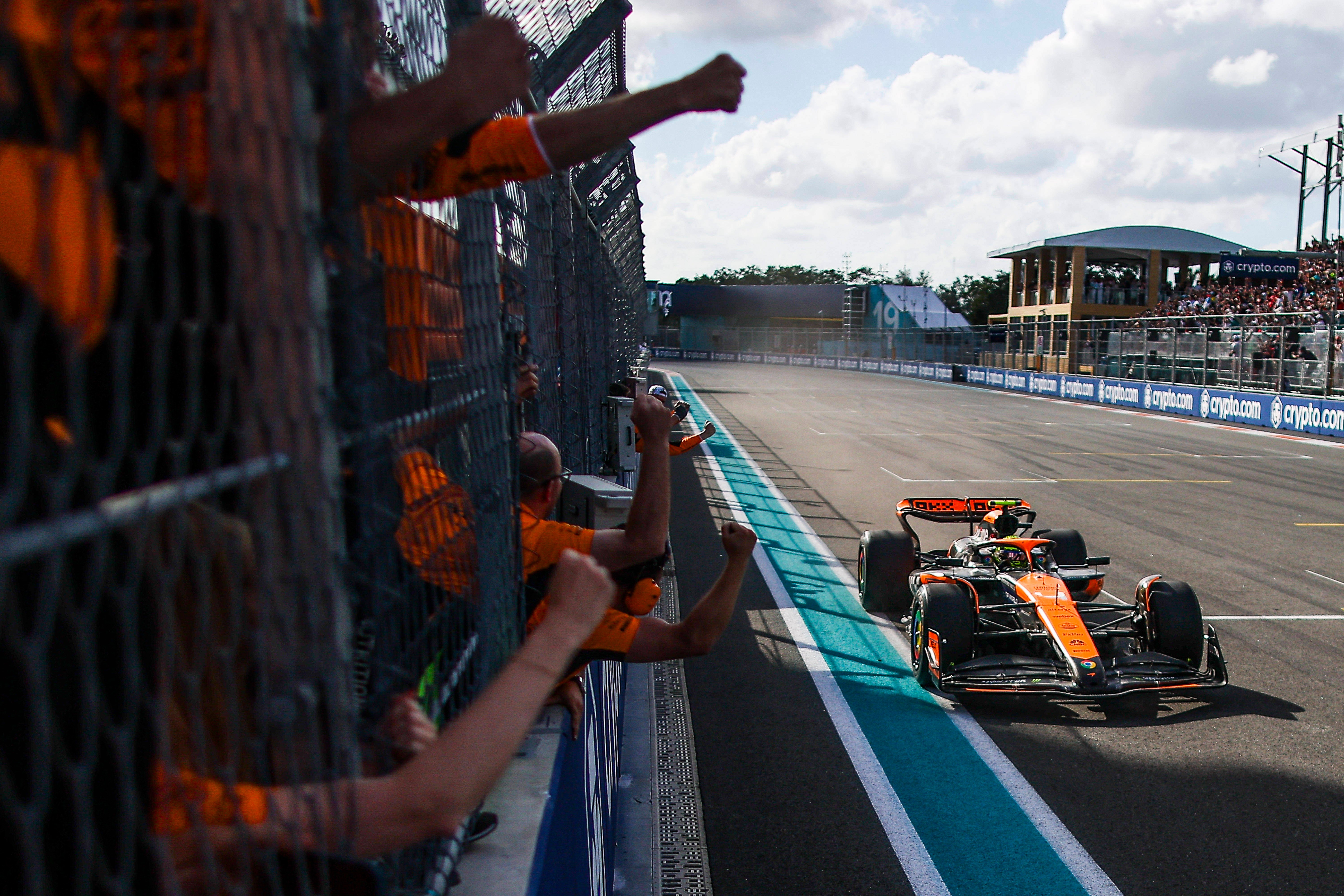 Lando Norris drives to win the 2024 Formula 1 Grand Prix of Miami with his team cheering for him.
