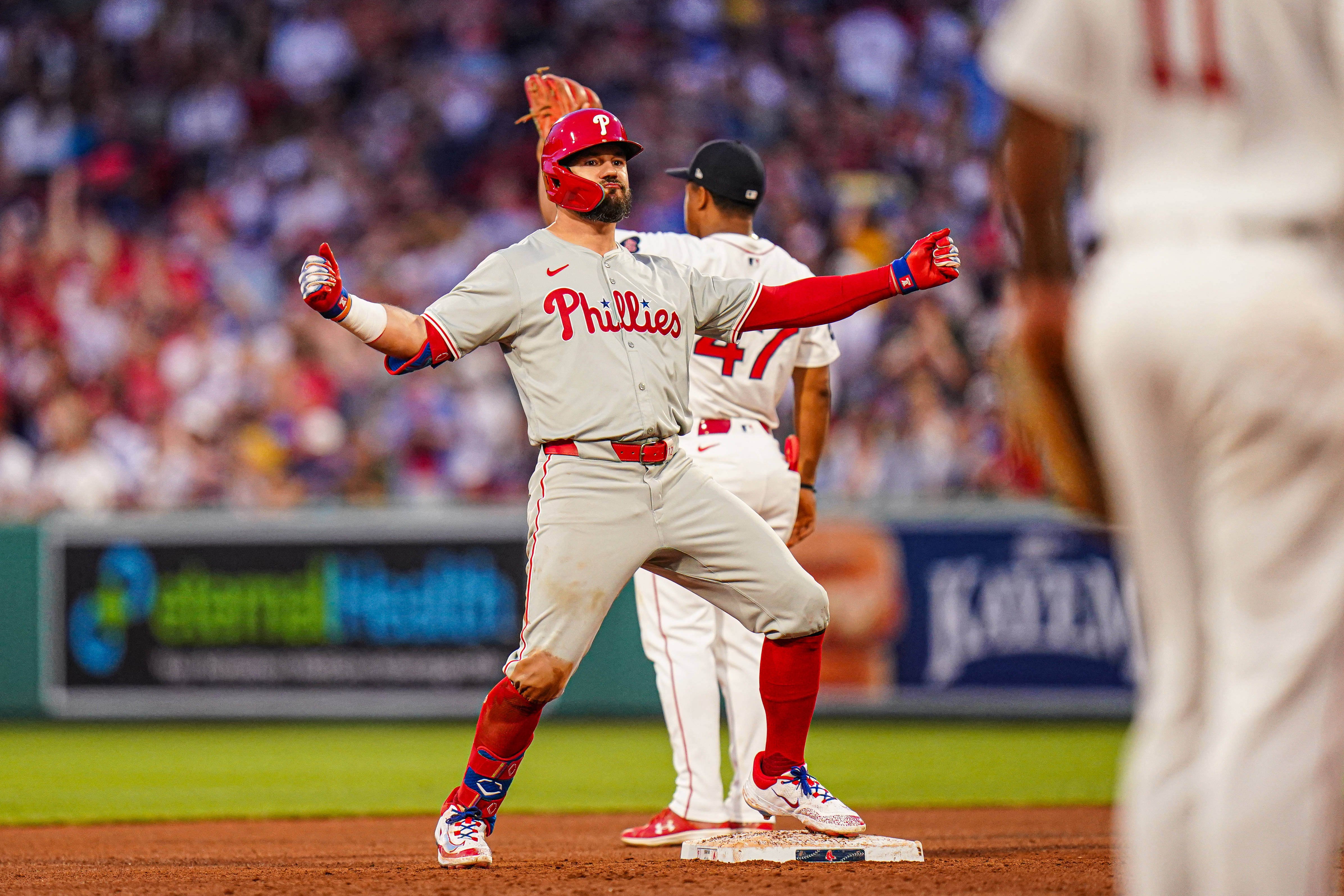 Philadelphia Phillies designated hitter Kyle Schwarber (12) reacts after hitting a double to drive in three runs against the Boston Red Sox.