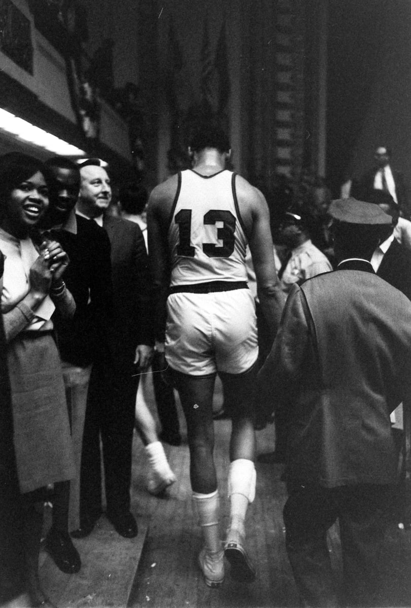 Wilt Chamberlain walks back of jersey 13